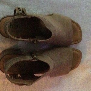 Tan suede open toe booties.